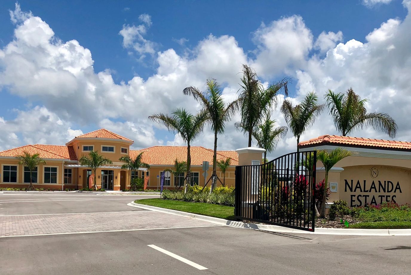 Exterior view of Nalanda Estates with palm trees