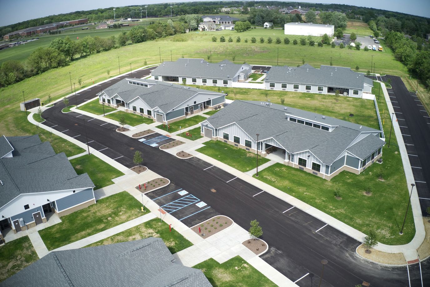 Aerial view of the facility with multiple buildings and parking.
