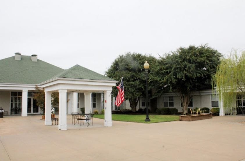 Exterior view of assisted living facility with American flag