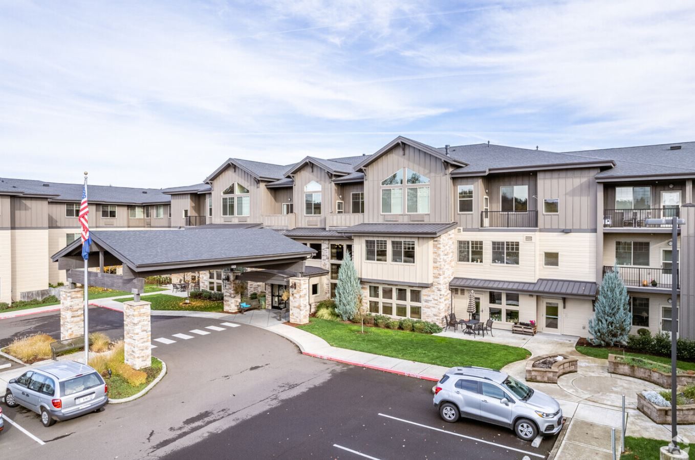 Exterior view of a senior living facility with gardens