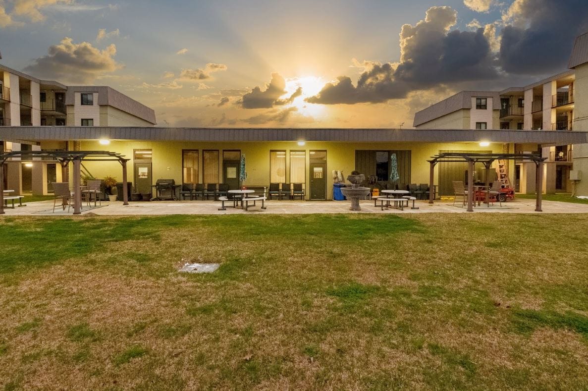 Exterior view of Tower Oaks Apartments at sunset