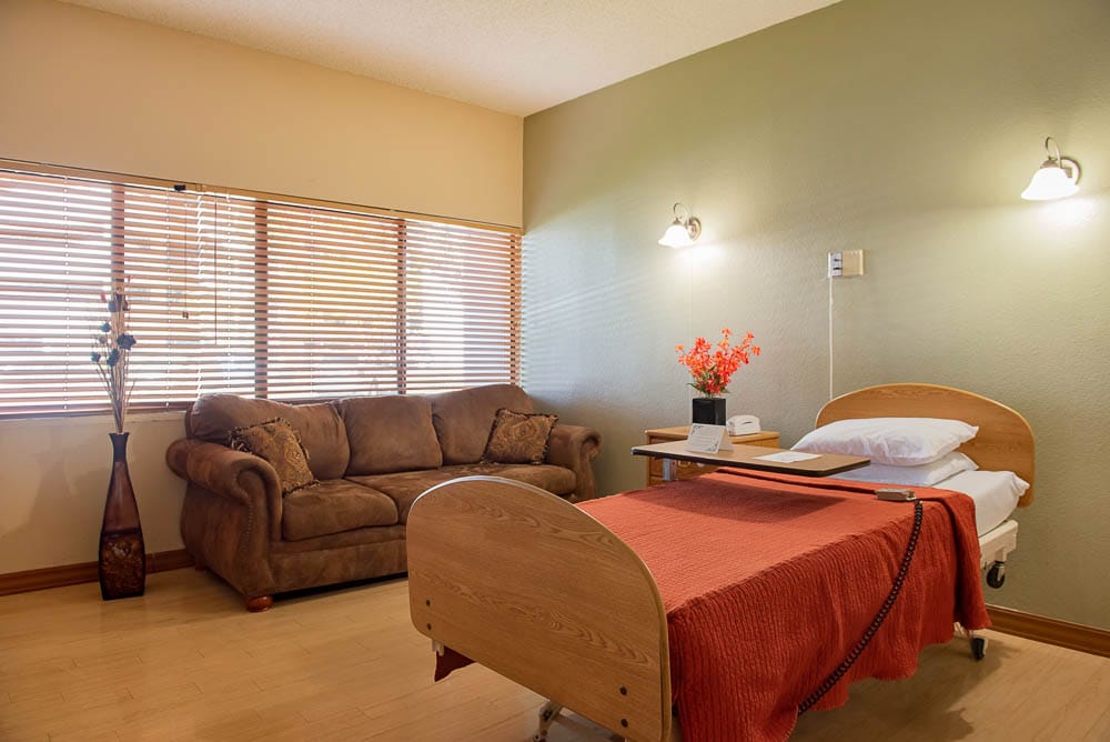 Cozy resident room with a bed and sofa
