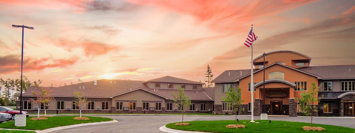 Exterior view of Majestic Pines Senior Living at sunset