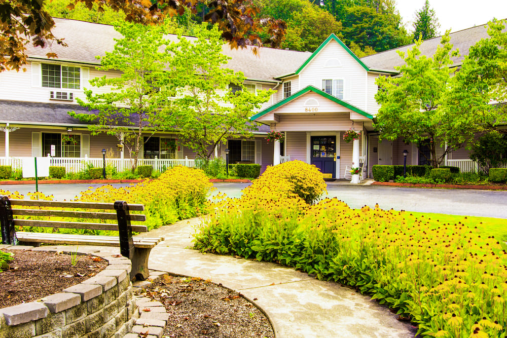 Beautiful exterior view of Milestone Senior Living with gardens