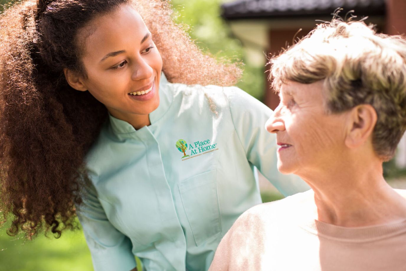A caregiver interacting with a resident outdoors