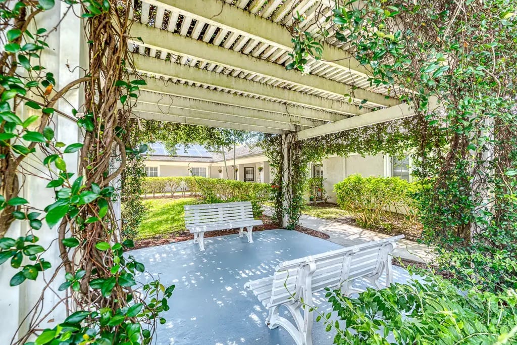 Outdoor shaded seating area with greenery