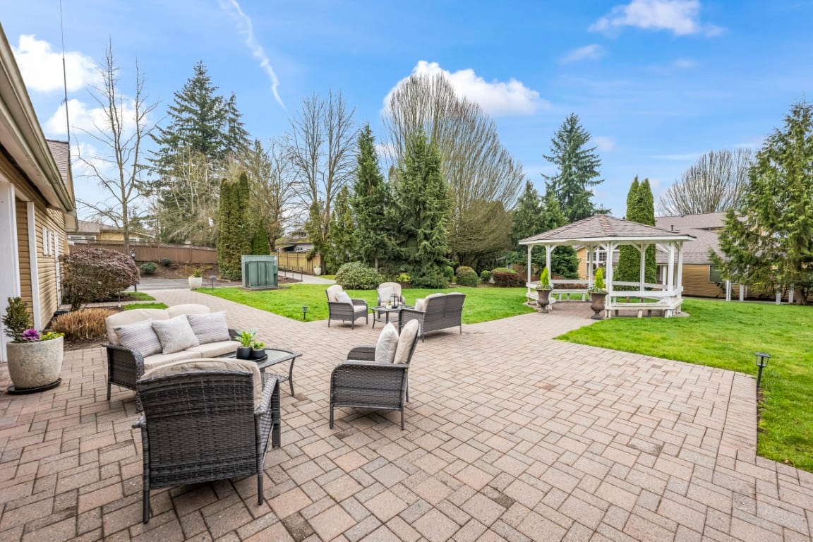 Outdoor seating area with gazebo and landscaped garden