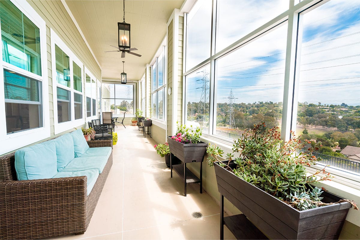 Outdoor balcony area with seating and planters