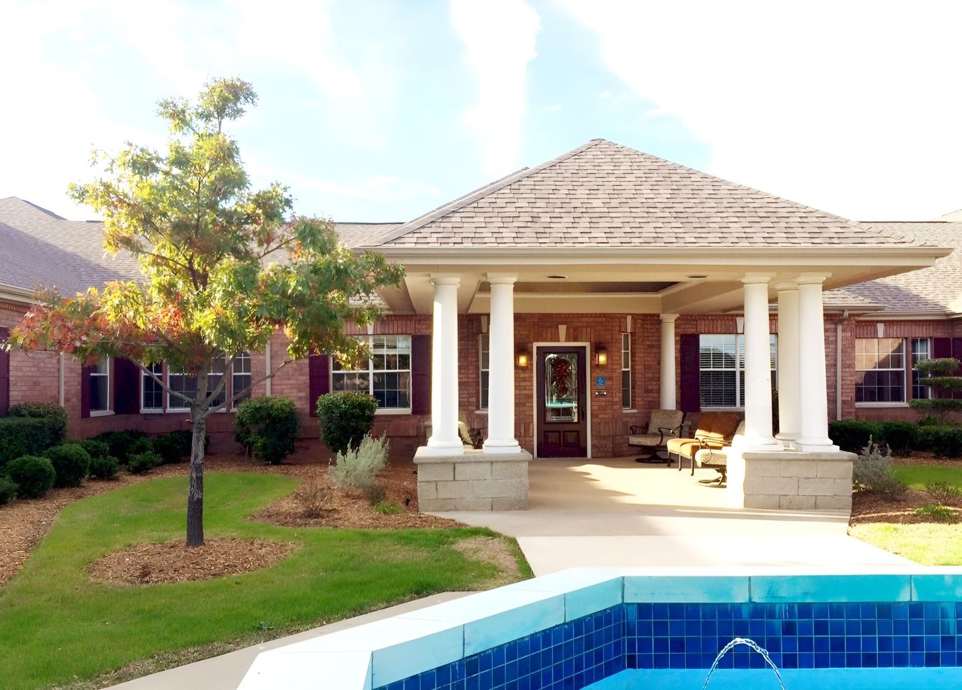 Exterior view of Grand Brook Memory Care with landscaping
