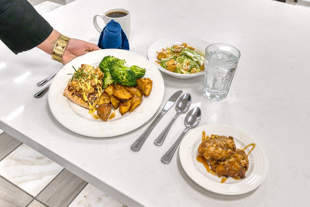 A dining room table setting with food and drinks
