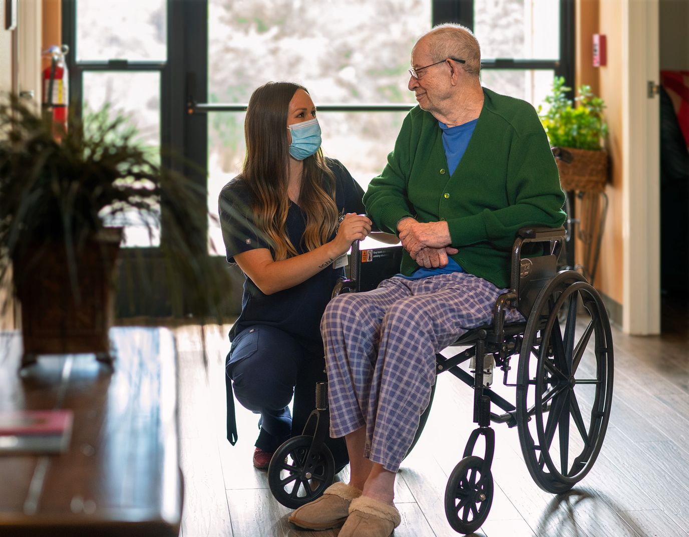 Staff member interacting with a resident in a lobby