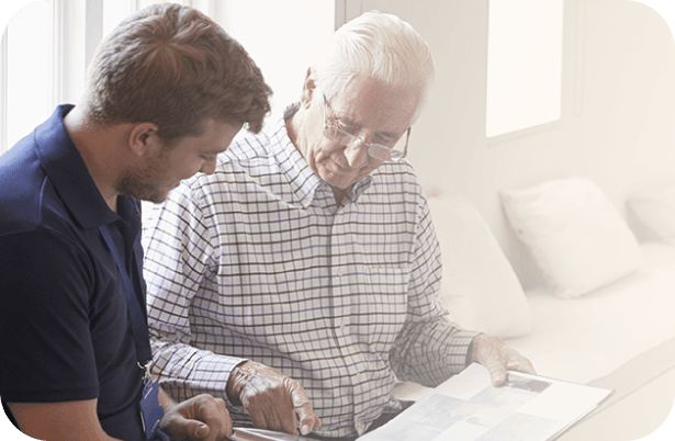 A resident and staff member looking at documents together