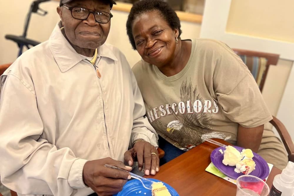 Two residents enjoying dessert at a table