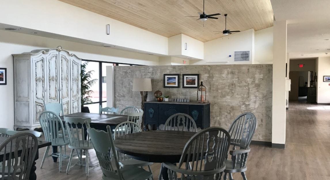 Dining area with wooden tables and blue chairs
