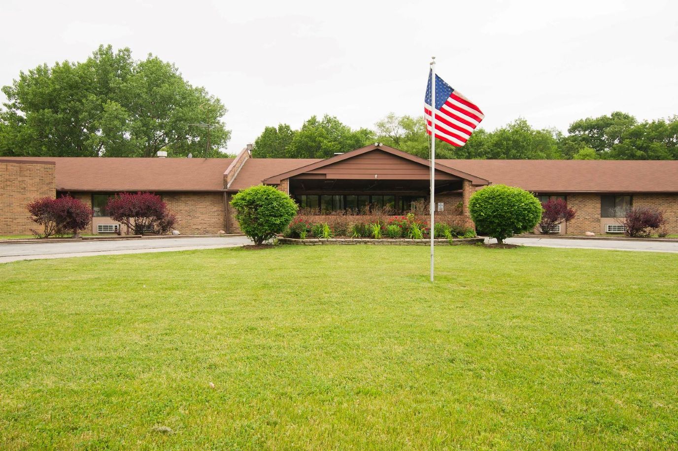 Exterior view of a senior care facility with landscaped lawn