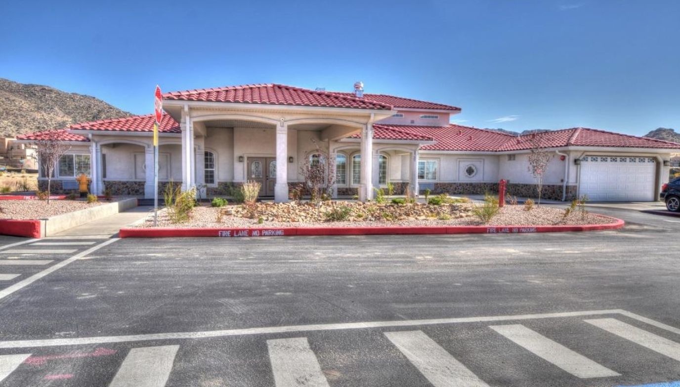 Exterior view of a nursing home facility with red tile roof