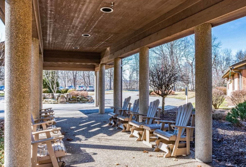 Outdoor seating area with wooden chairs and landscape