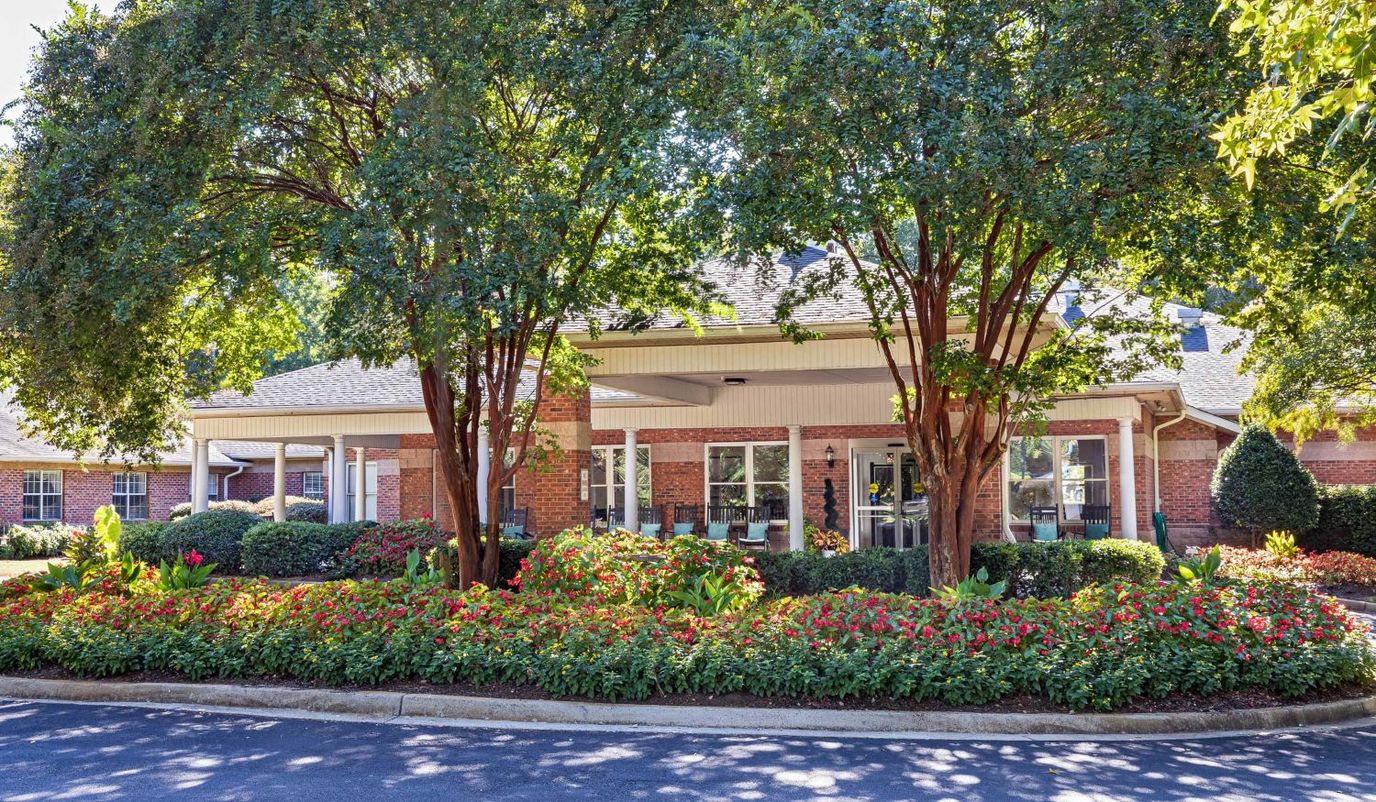 Exterior view of the facility entrance surrounded by flowers