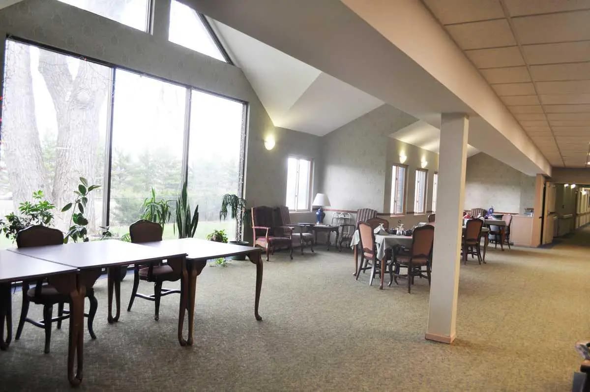 Spacious lounge area with tables and chairs near large windows