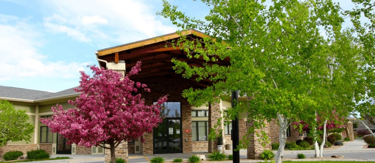 Front exterior of Larchwood Inns with blooming trees