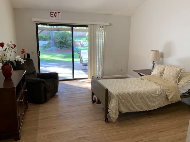 Private resident room with a bed and seating area