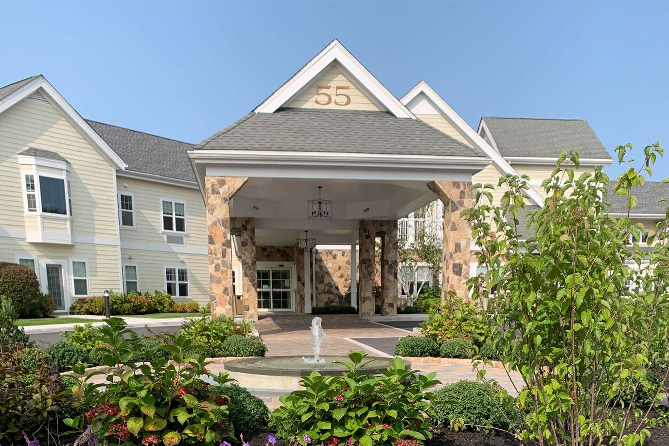 Entrance of a senior living facility with landscaping