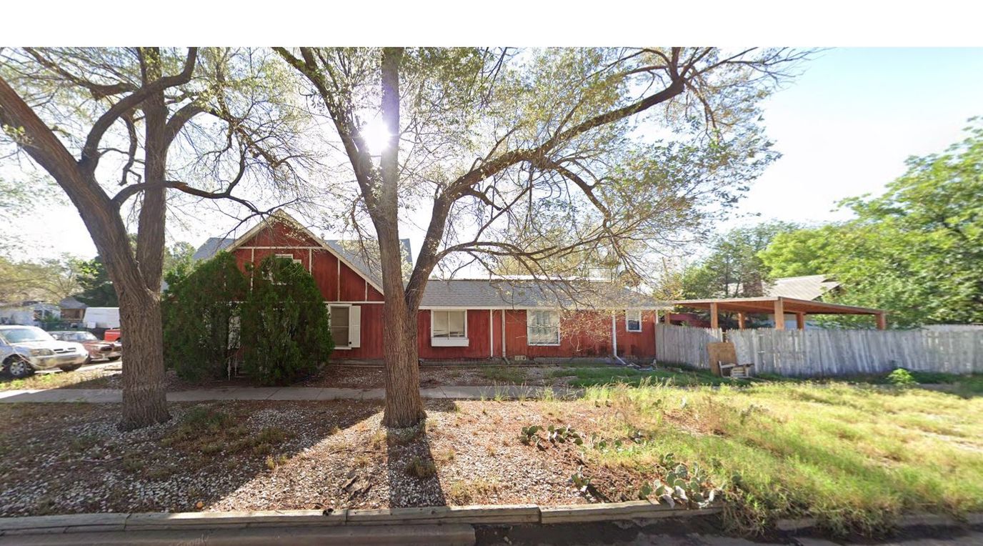 Exterior view of a red building with trees