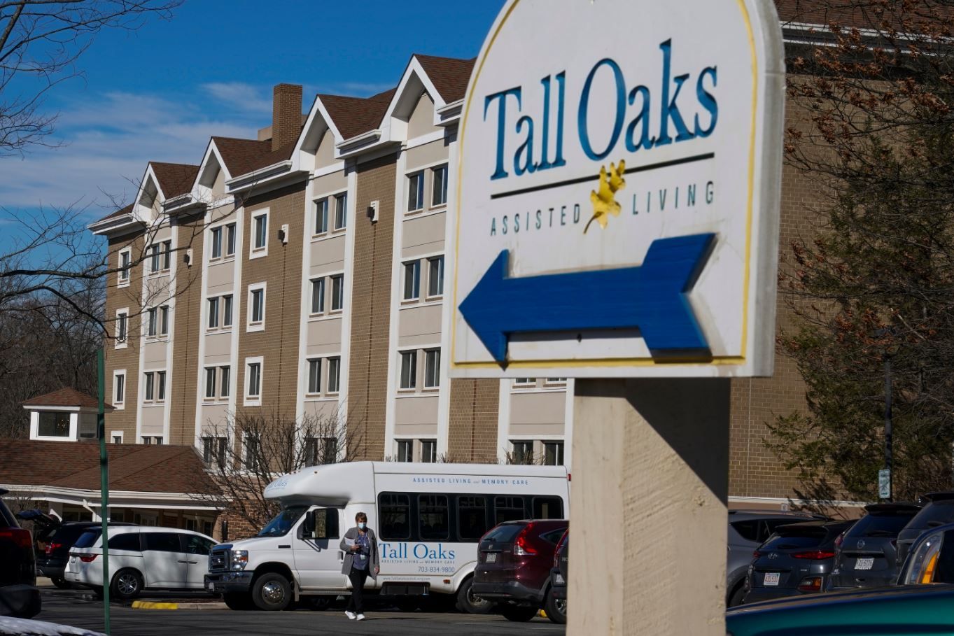 Sign for Tall Oaks Assisted Living with facility in background
