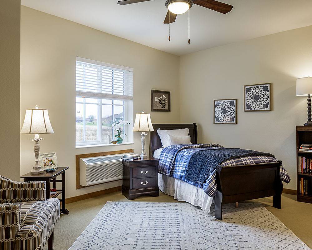 Well-furnished resident room with bed and decor