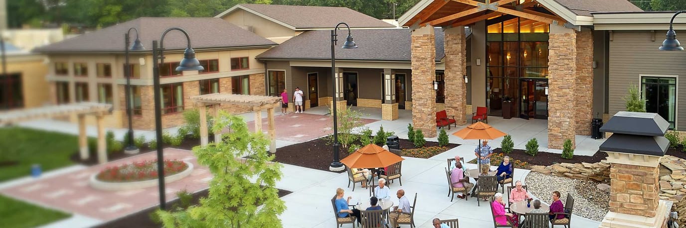 Outdoor gathering space with residents enjoying the patio