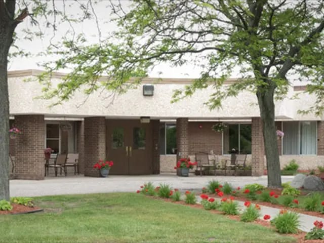 Exterior view of a senior living facility with seating area