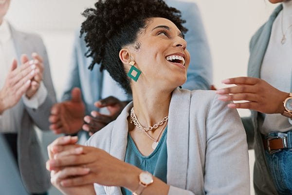Accent Care – Portland, hospice care in Portland, OR — Smiling woman surrounded by applauding people in business attire