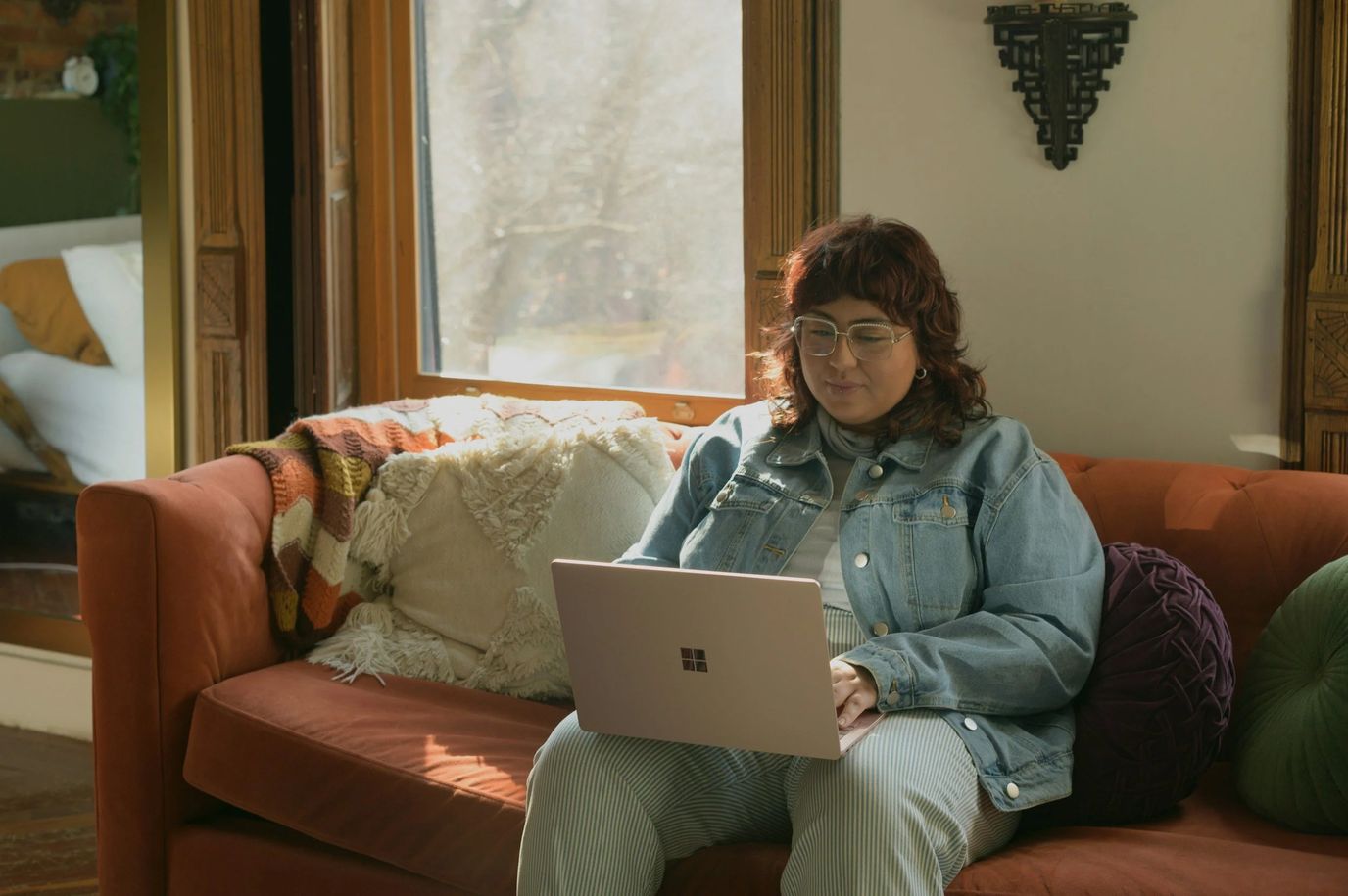 Resident using a laptop in a cozy indoor space.
