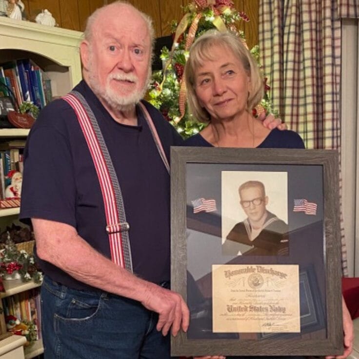 Elderly man and woman with a military certificate