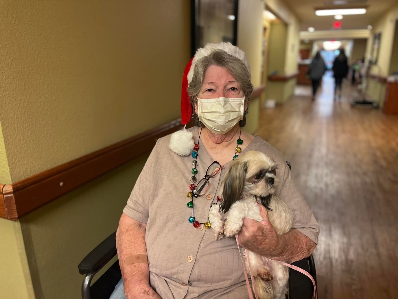 Senior resident with a dog and holiday attire
