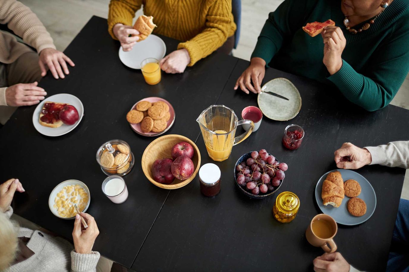 Residents enjoying breakfast around a table.