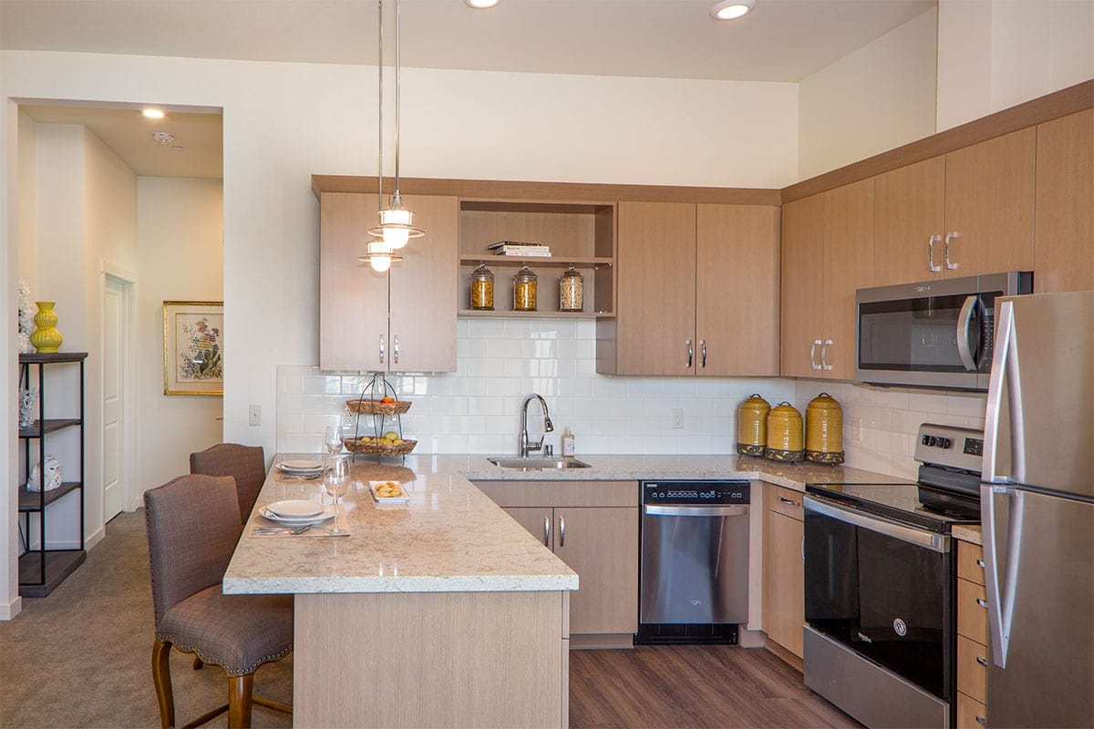Modern kitchen area with seating and appliances
