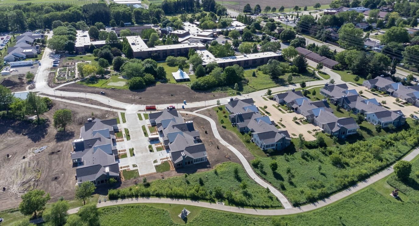 Aerial view of a large senior living campus with gardens