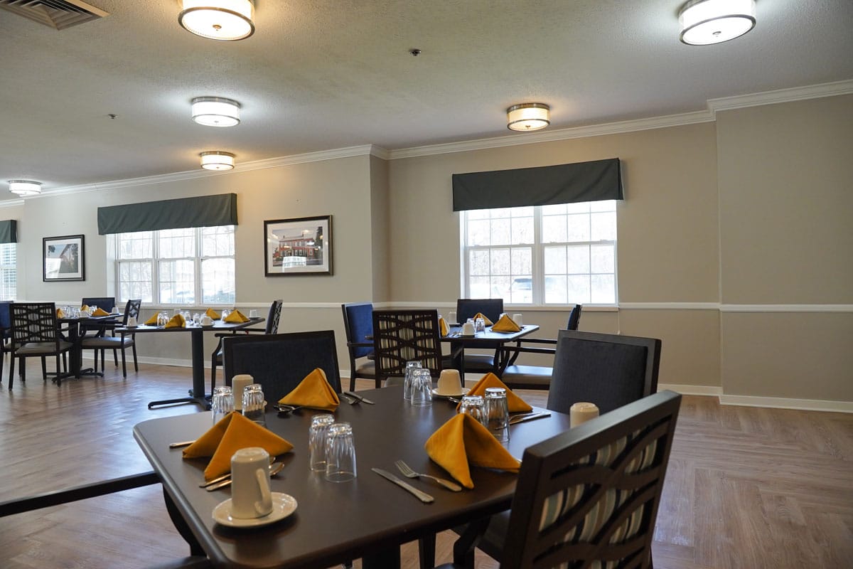 Dining area set up for meal service with tables and decor