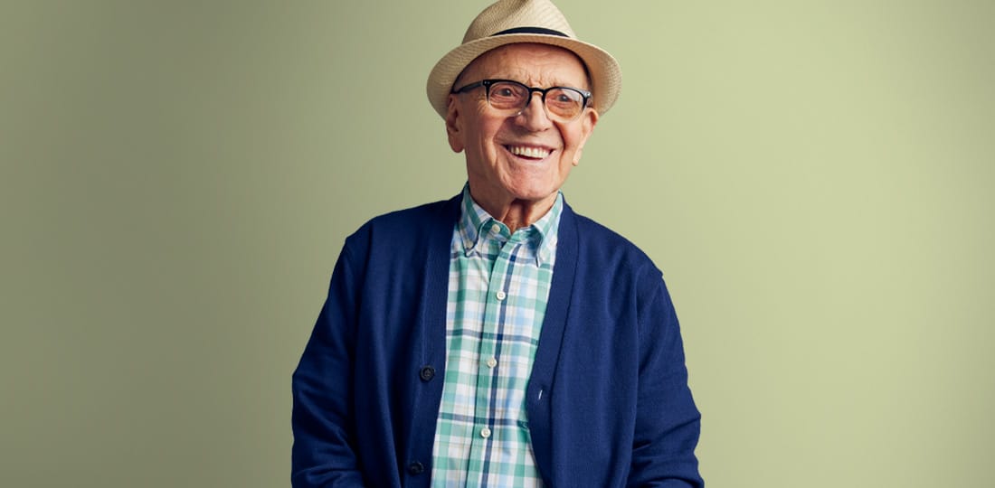 Smiling senior man wearing a hat and glasses
