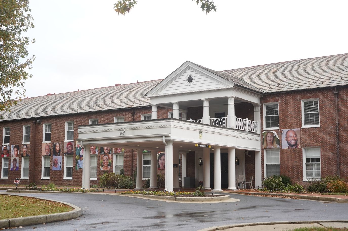 Exterior view of a senior living facility with resident photos