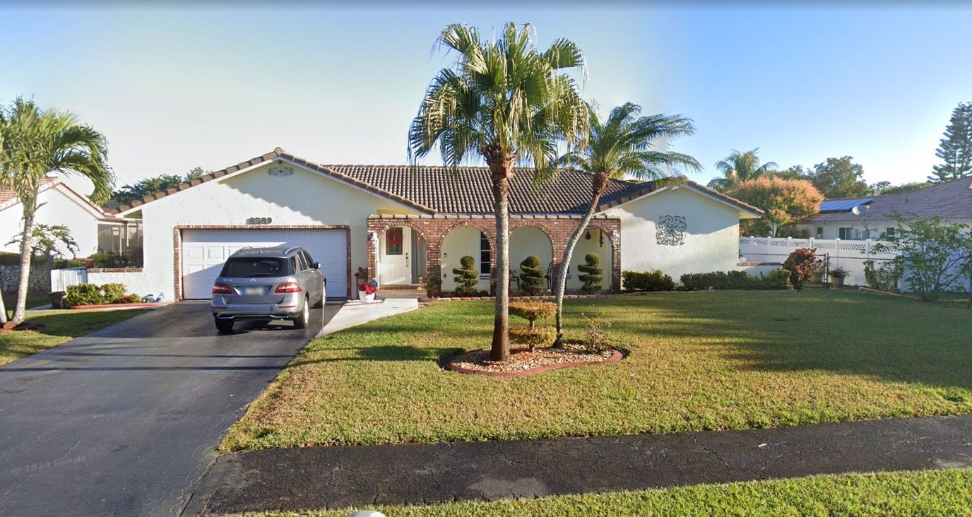 Exterior view of a residential building with palm trees