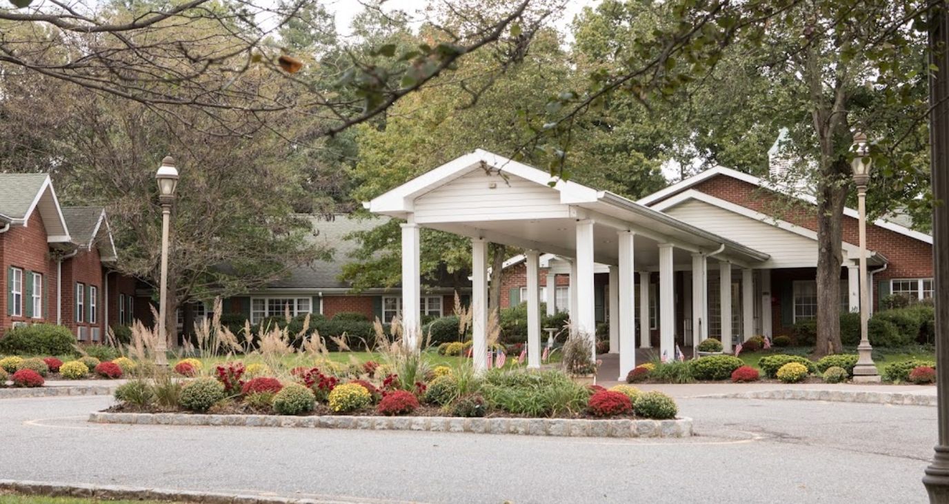 Exterior view of the facility with landscaped gardens