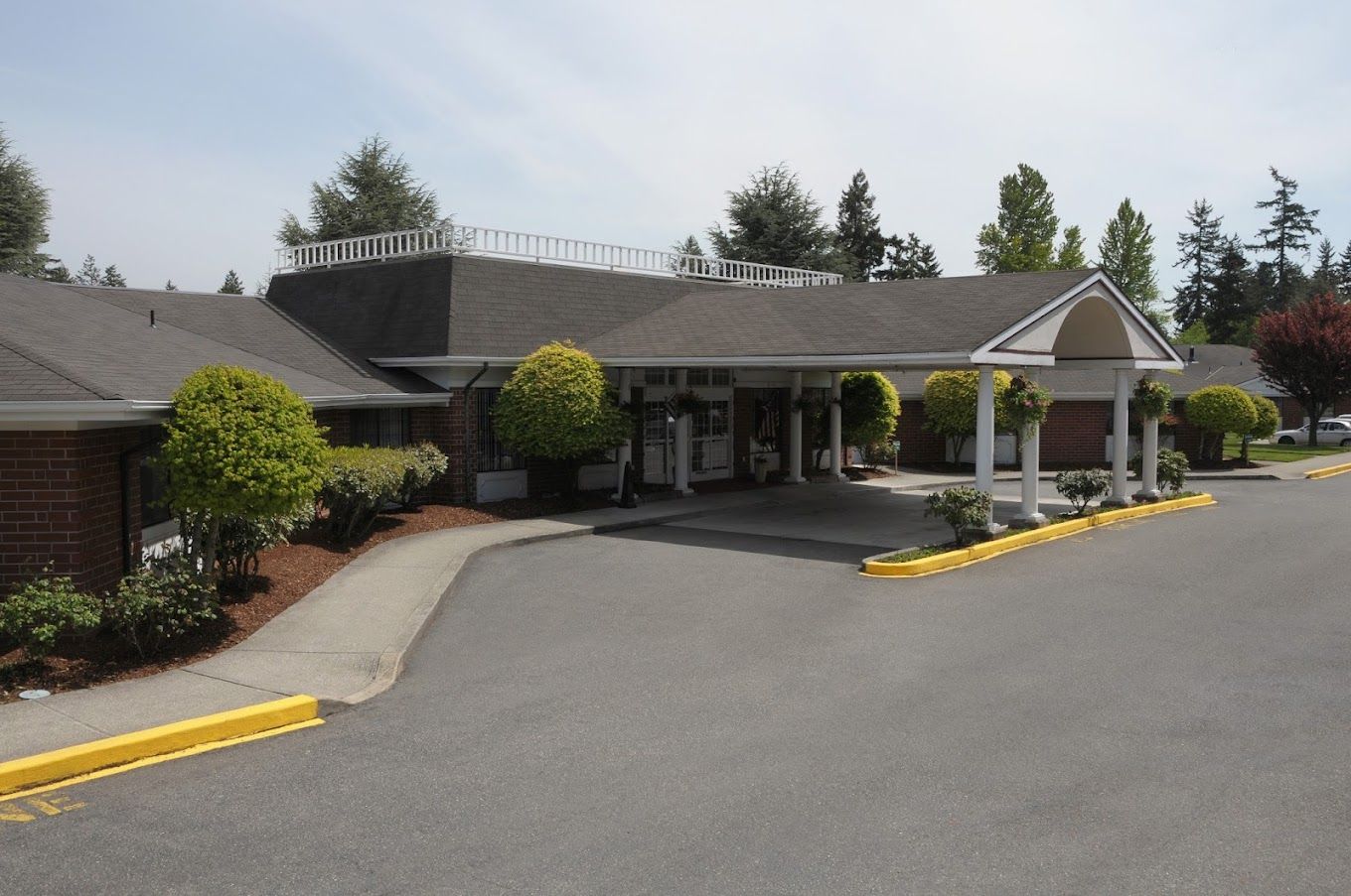 Exterior view of Hallmark Manor entrance and landscaping