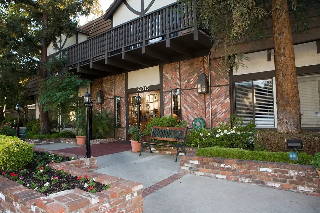 Exterior view of a senior living facility with landscaped entrance