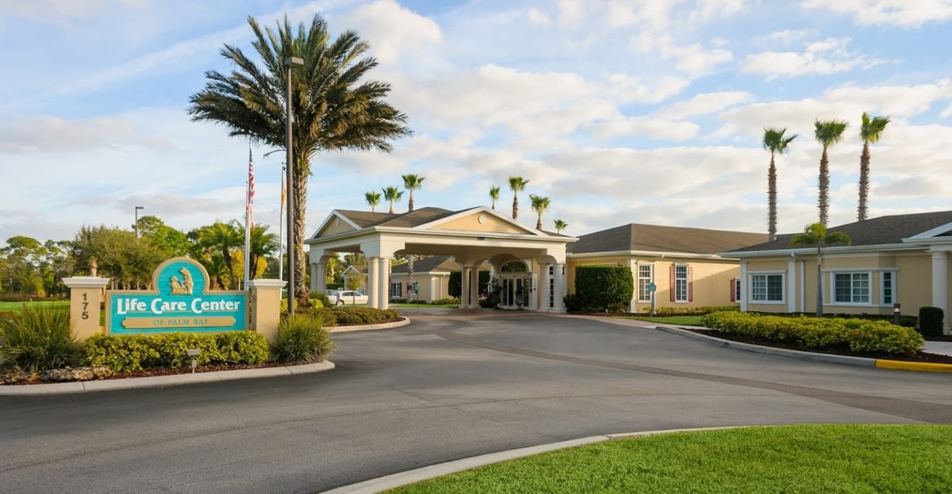 Exterior view of Life Care Center with palm trees