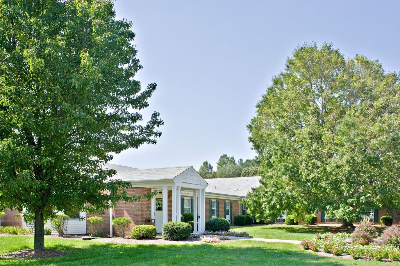 Exterior view of Milford Center with landscape and building