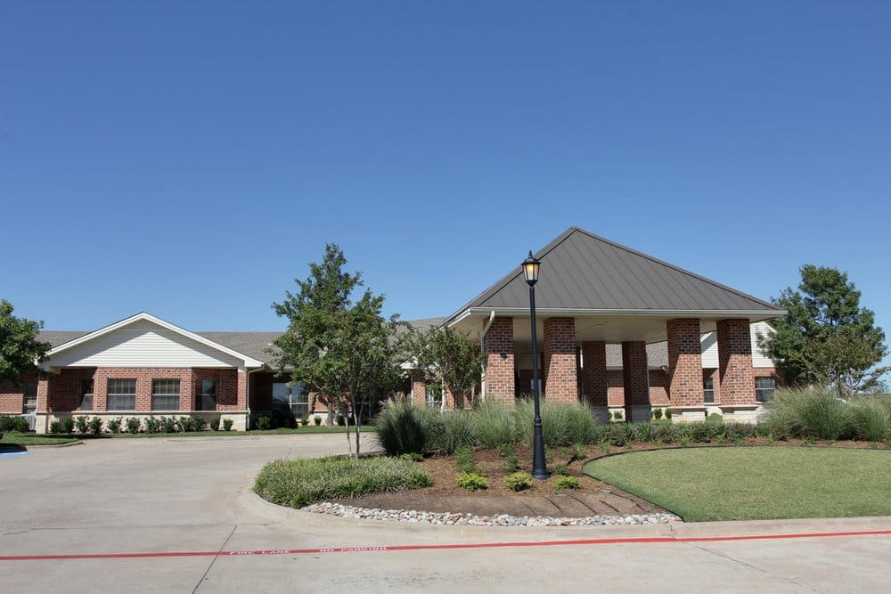 Exterior view of a senior care facility with landscaping
