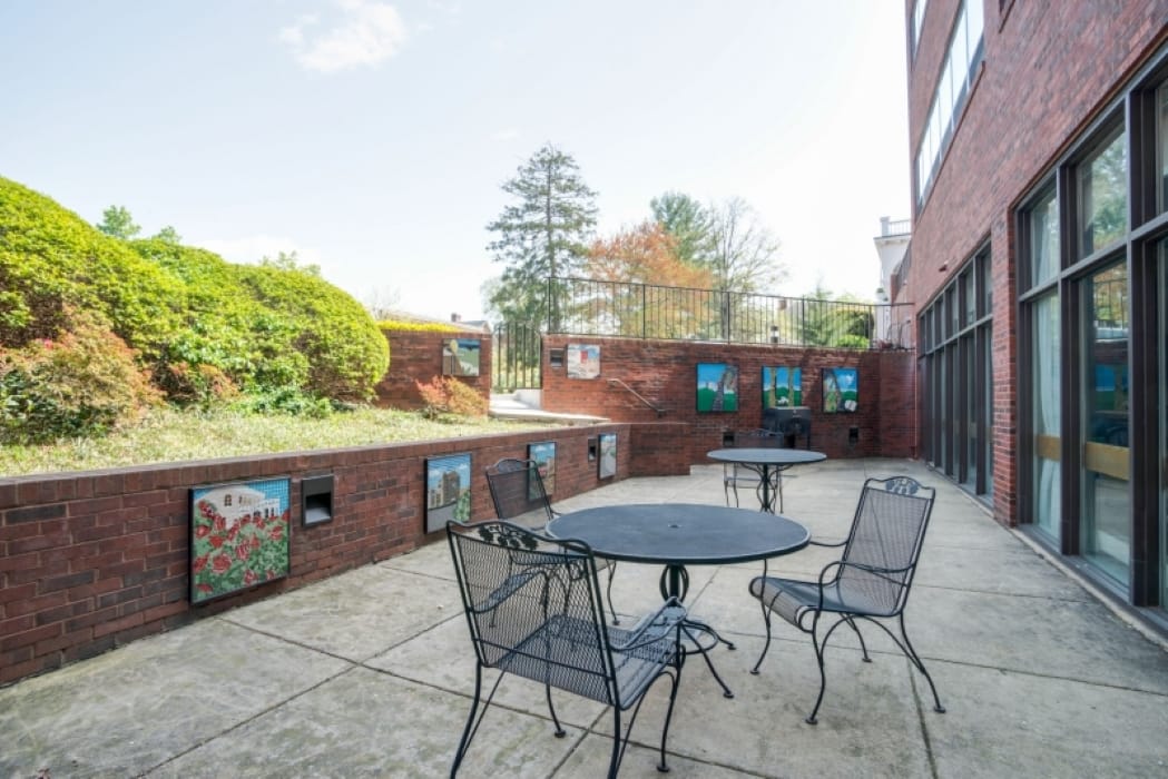 Outdoor seating area with tables and garden view