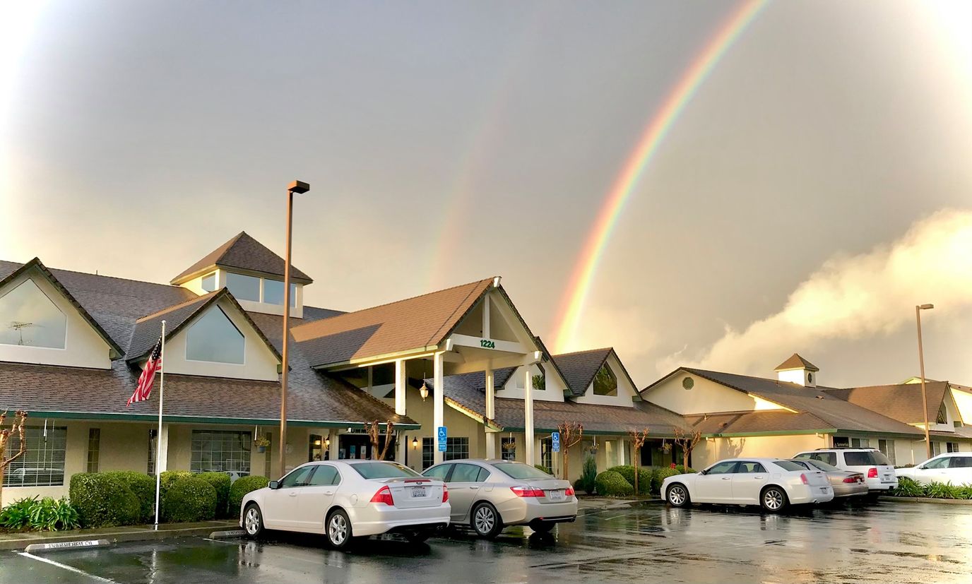 Exterior view of Summerfield Senior Living with rainbow